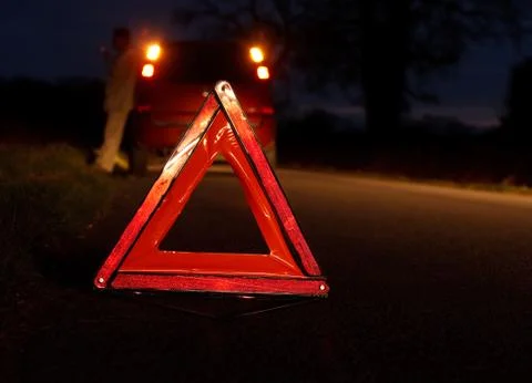 Broken down car at night with warning signal Stock Photos