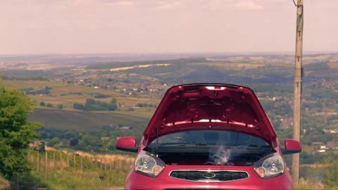 Broken down car with smoke coming out of engine Stock Footage 310942206
