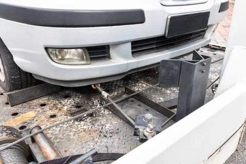 Broken down car towed onto flatbed tow truck Stock Photos