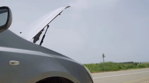 Broken down car with trunk open on the side of a country road Stock Footage 107543316