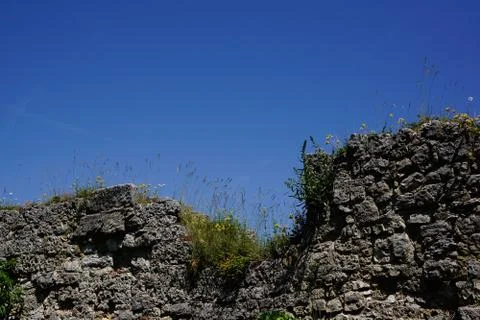 Broken down castle wall and blue sky Stock Photos