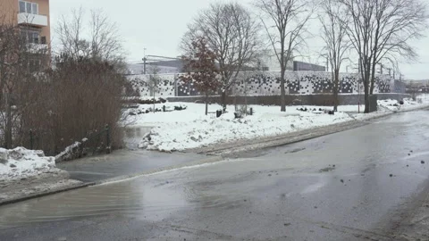 Broken drain pipe on street causing flooded roads Stock Footage 153496063