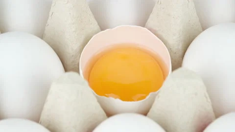 Broken egg and whole eggs in box, rotation Stock Footage 202300864