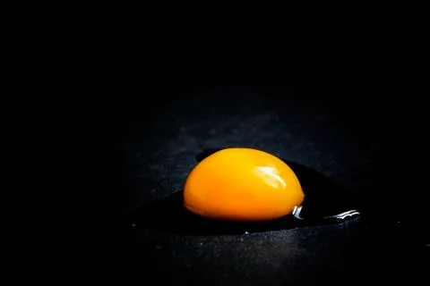 Broken egg, black background, selective focus Stock Photos