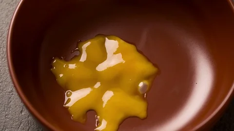 Broken Egg falls in Pan for cooking scrambled eggs Slow motion Stock Footage 103041294