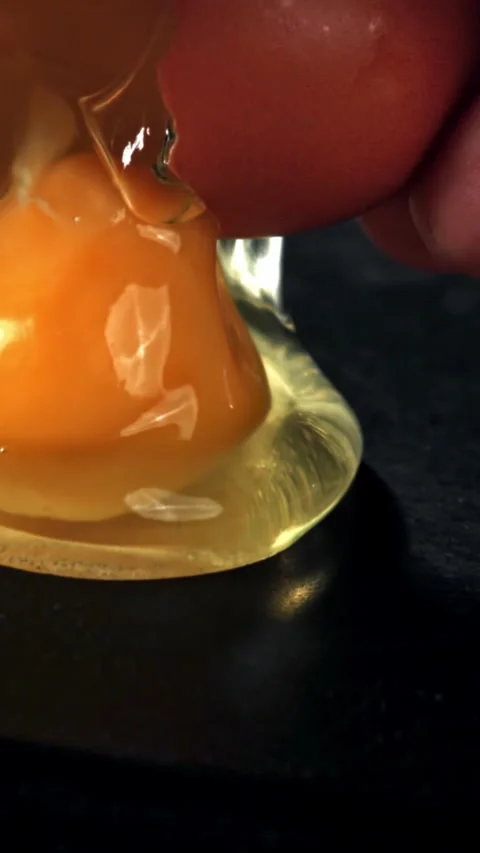 The broken egg falls into the pan. Filmed on a high-speed camera at 1000 fps Stock Footage 335363328