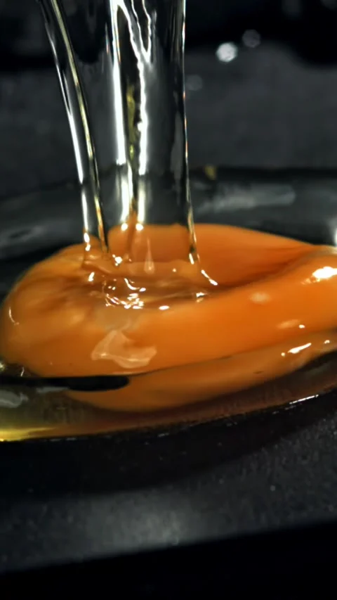 The broken egg falls into the pan. Filmed on a high-speed camera at 1000 fps Stock Footage 335364965