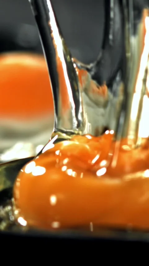 The broken egg falls into the pan. Filmed on a high-speed camera at 1000 fps Stock Footage 335368870