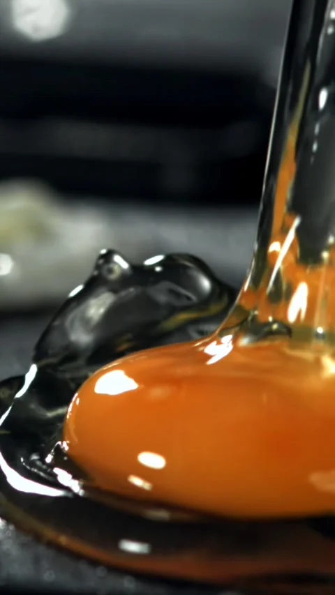 The broken egg falls into the pan. Filmed on a high-speed camera at 1000 fps Stock Footage 335377793