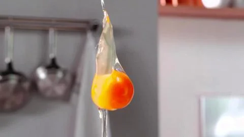 The broken egg falls in slow motion Stock Photos
