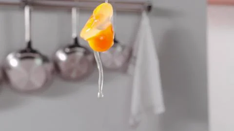 The broken egg falls in slow motion Stock Photos