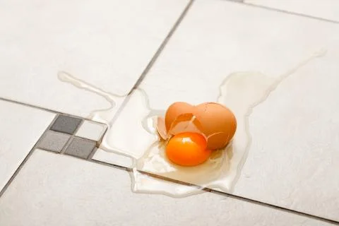 Broken egg on the floor Stock Photos