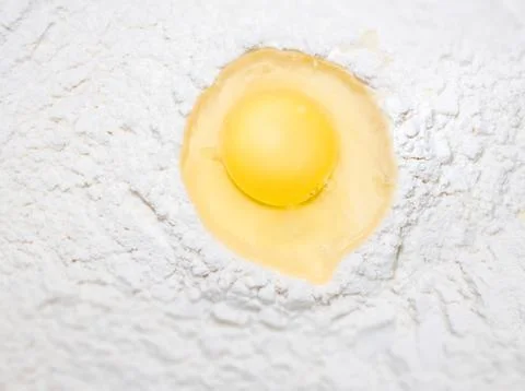 Broken egg on flour, for making bread Stock Photos