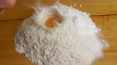 Broken egg on flour, means for bakeries. Slow motions. Stock-Footage 33941934