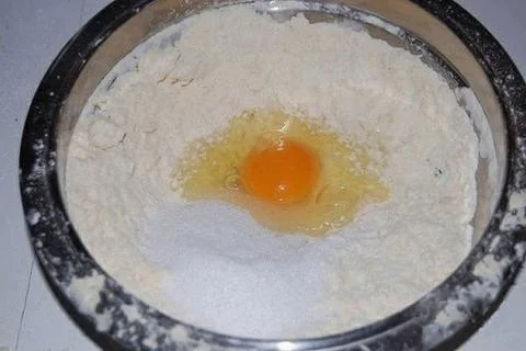 Broken egg in flour Stock Photos