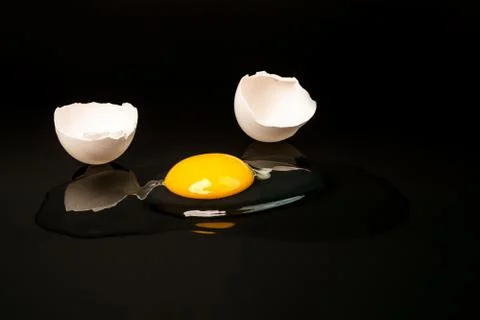 Broken egg isolated on the black background. Broken egg on black Stock Photos