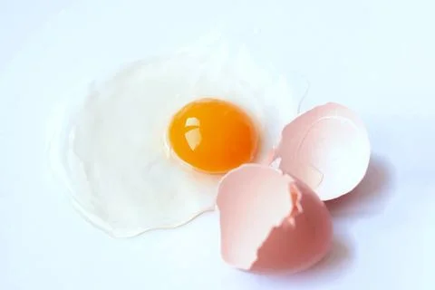 Broken egg isolated on white background. Stock Photos