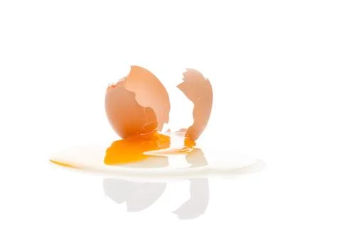 Broken egg isolated on white. Stock Photos