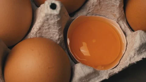 The Broken Egg lies in the Container Among the Whole Eggs Stock Footage 168469216