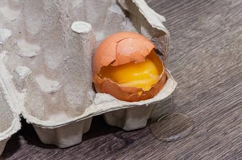 Broken egg in a package Stock Photos