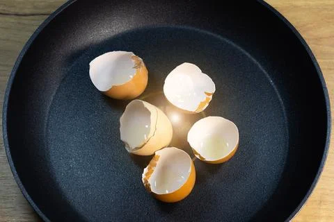 Broken egg shells on the pan. Expensive price on eggs in Russia. Overpriced.. Stock Photos