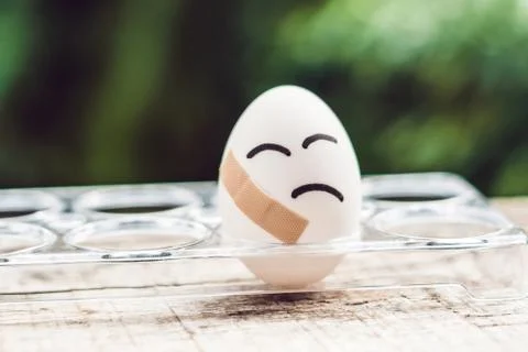 Broken egg with sticking plaster. Concept of brittleness and pain Stock Photos