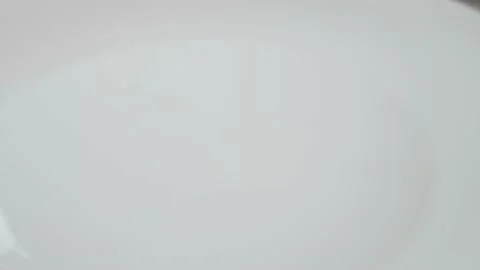 Broken egg on a white table. Up close The cook broke the egg. The white egg Stock Footage 207167771