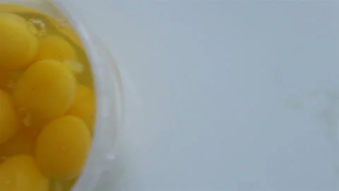 Broken eggs close-up. The hand rotates the container and removes the eggs from t Stock Footage 142241544