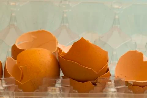Broken eggs inside the container Stock Photos