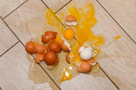 Broken eggs on the kitchen floor Stock Photos