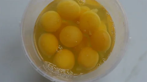 Broken eggs in a single-use plastic container.  Real time, top view, natural lig Stock Footage 142241565
