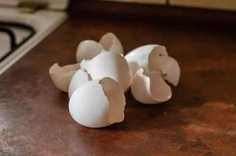 Broken eggshell on the kitchen table. 스톡 사진