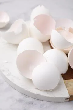 Broken eggshells on light marble table, closeup 스톡 사진