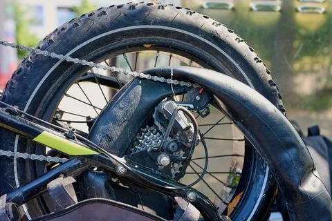 Broken electric bicycle with pulled out inner tube and flat rear tire Stock Photos