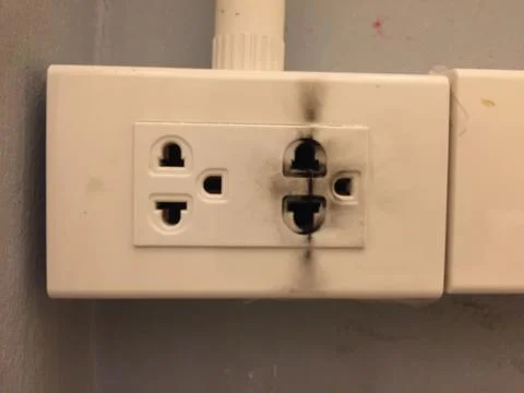 Broken electric socket with electric shock clue Stock Photos