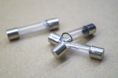Broken electrical fuses with split glass housing. Broken glass tube. Hot-melt Stock Photos