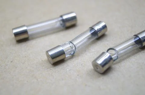 Broken electrical fuses with split glass housing. Broken glass tube. Hot-melt Stock Photos