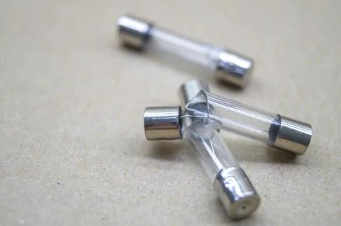 Broken electrical fuses with split glass housing. Broken glass tube. Hot-melt Stock Photos