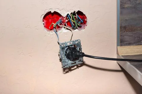 Broken electrical outlet when plugged into an electrical appliance. Risk of s Stock Photos