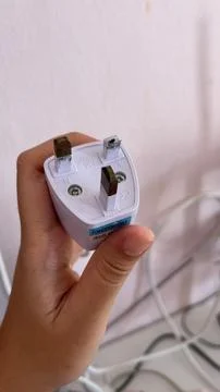 Broken Electrical Plug Held in Hand Stock Photos