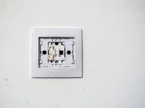 Broken electrical switch on the wall. Switch without button. Disassembled d.. Stock Photos