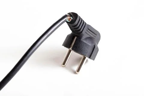 Broken electrical wire with a plug on a white background, isolate, close-up Stock Photos
