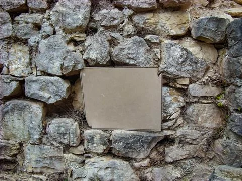 Broken empty tablet on a background of ancient stone bricks Stock Photos
