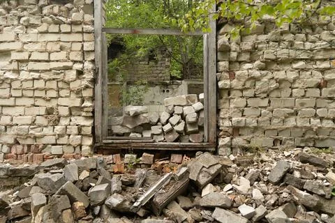 A broken, empty window of building ruins from Soviet times. Stock Photos