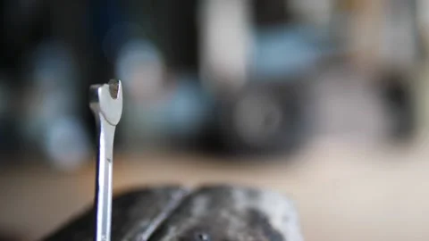 Broken end wrench in vice in old garage Stock Footage 195982006