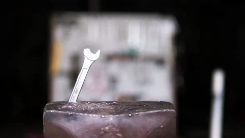 Broken end wrench in vice in old garage tools in background Stock Footage 195982012