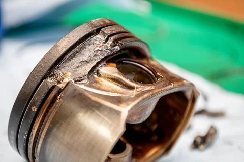 Broken engine piston, broken piston parts, engine damage and further repairs Stock Photos