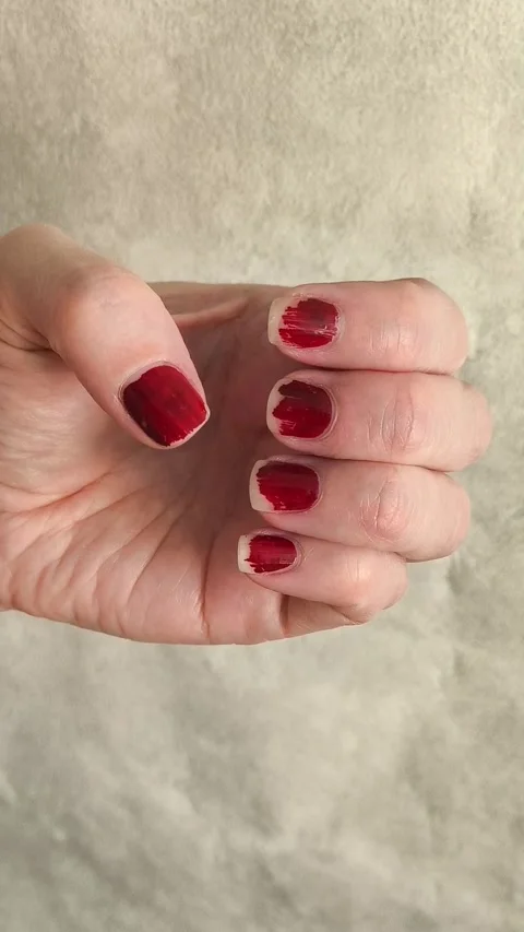 Broken, erased, chipped red nail polish. Spoiled manicure on your hands. Stock Footage 325366459