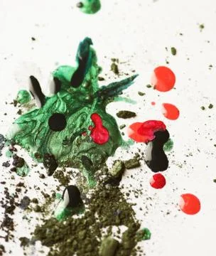 Broken eye-shadows and drops of nail lacquer Stock Photos