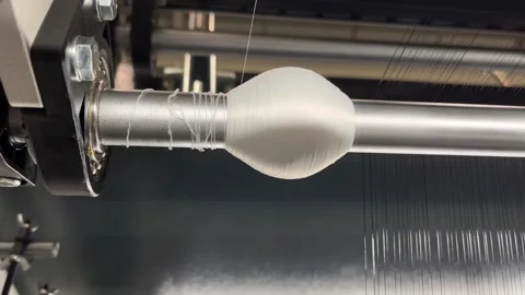The broken fiber is wound up in the wrong place in the knitting machine Stock Footage 335957213